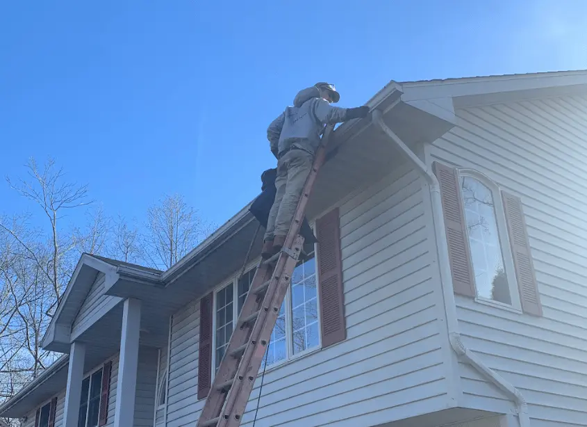 Gutter cleaning and maintenance being performed by Willowick Power Washing in Willowick